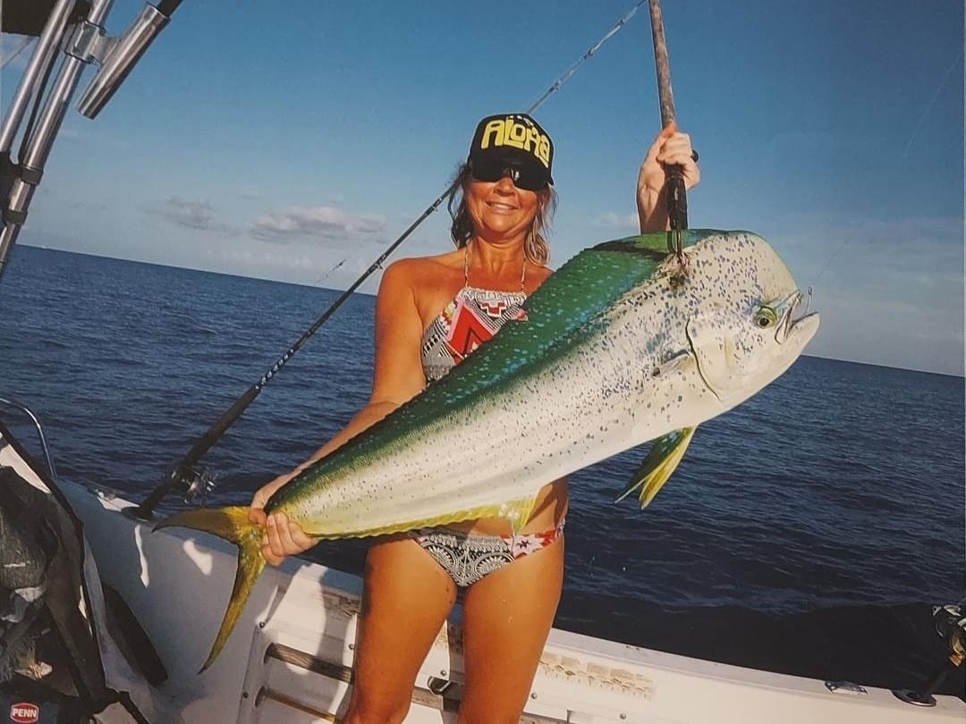 Angler with a mahi-mahi (dolphin) caught trolling offshore of Lake Worth, Florida