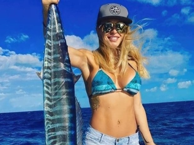 Angler holding a wahoo caught offshore of Palm Beach County, Florida