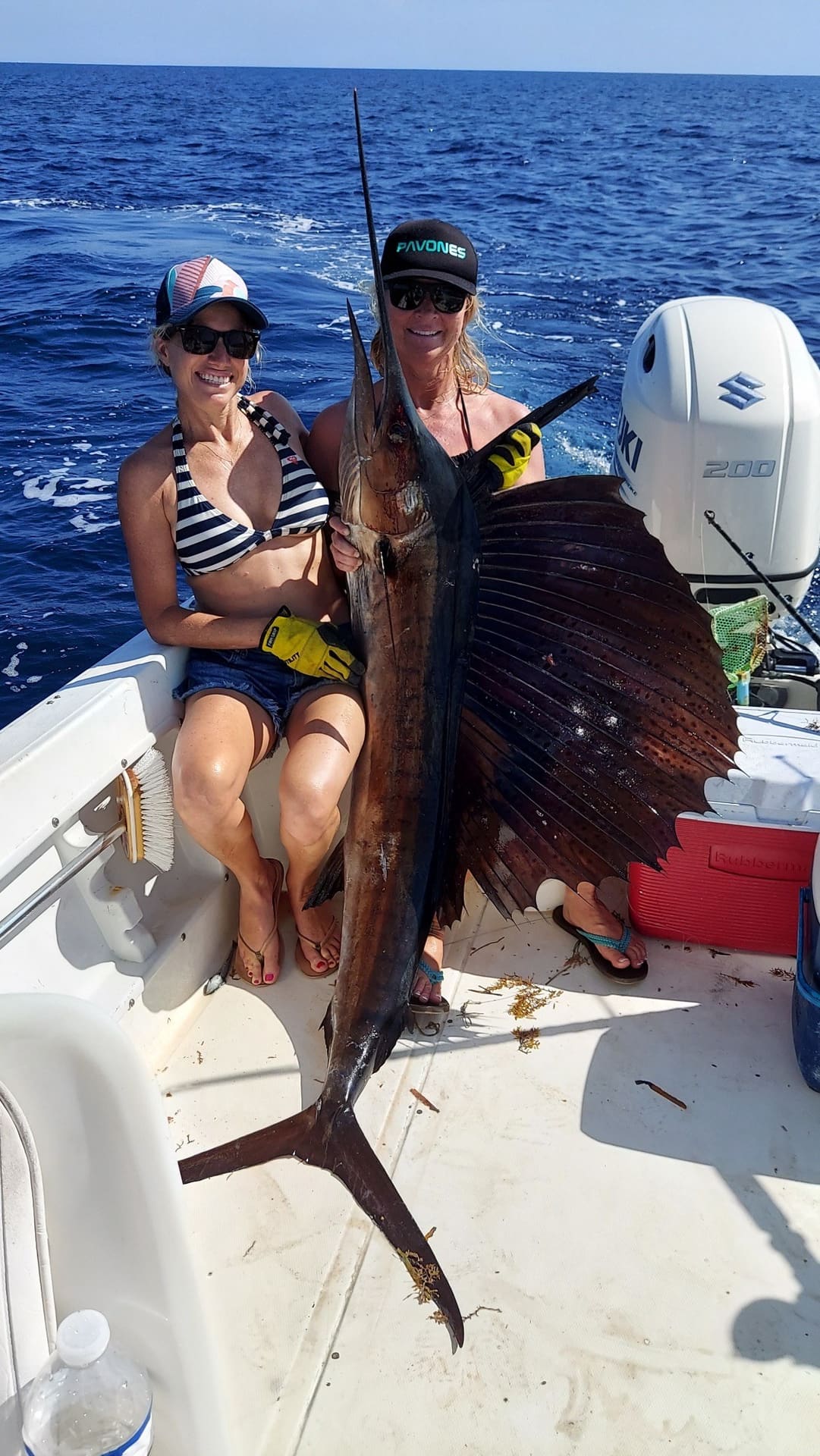 Two anglers holding a sailfish caught offshore of Boynton Beach on an Angle Drop Charters trip