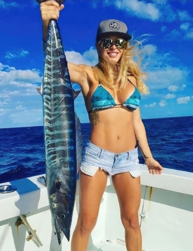 Angler holding a wahoo caught offshore of Palm Beach County, Florida
