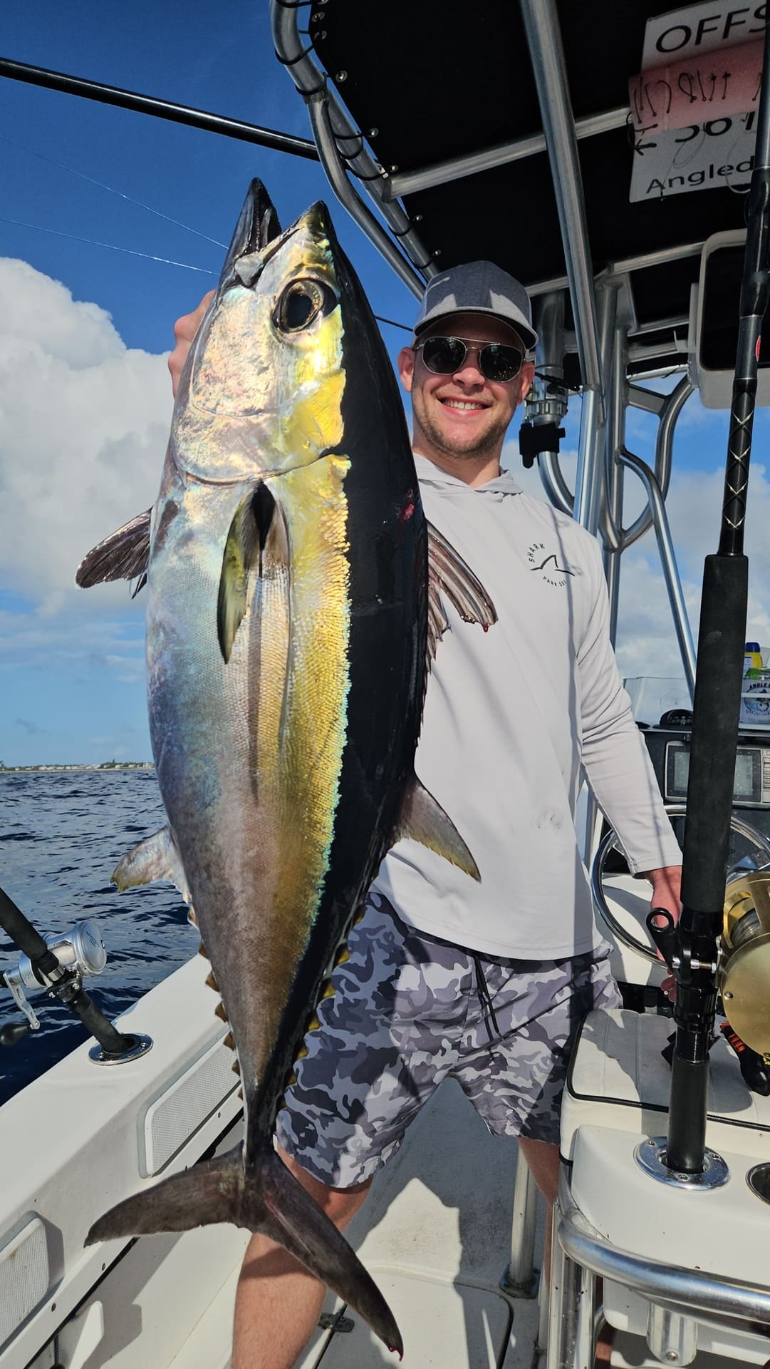 Angler holding a yellowfin tuna aboard the Angle Drop Charters center console off Palm Beach
