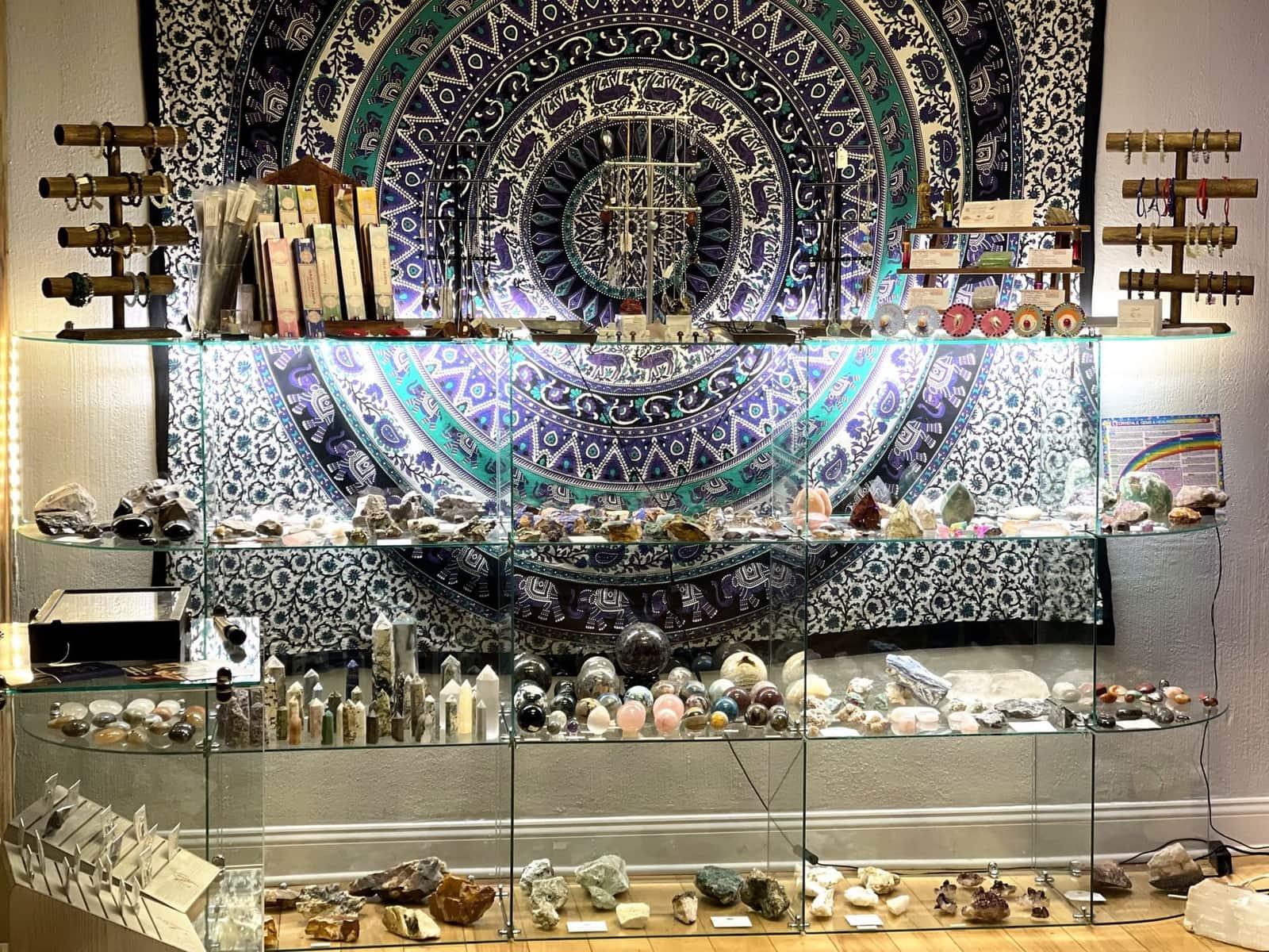 The wall of cases at Tremont Rocks: towers, spheres and rough stones under the mandala tapestry