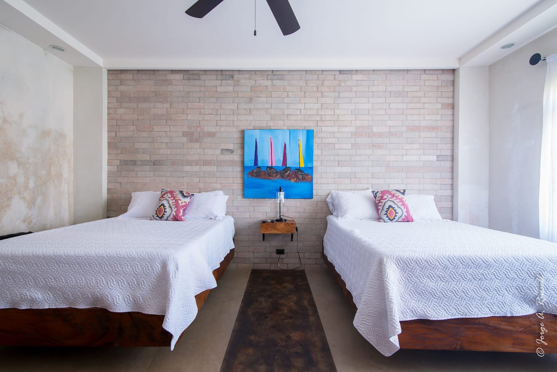 A shared room at the villa with two queen beds