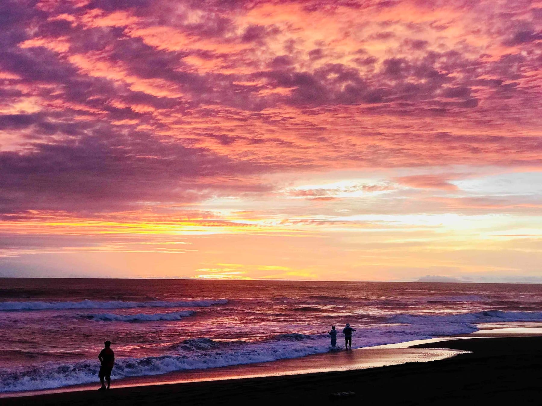 A pink and orange sunset over the beach