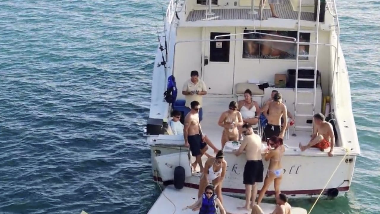 A group on the yacht's back deck