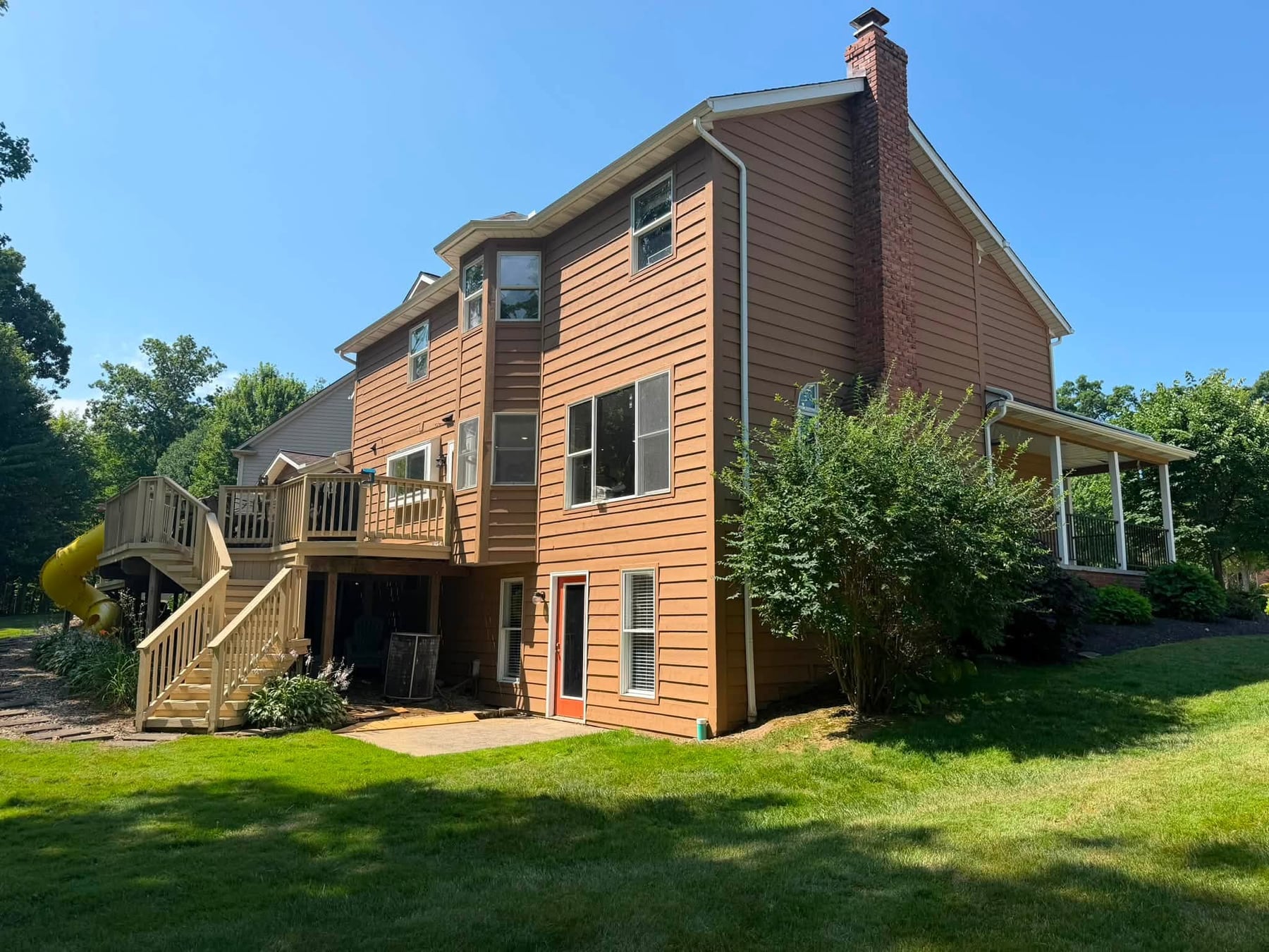 The side of a house with new cedar stain