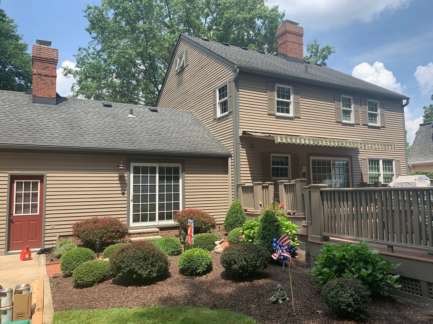 A tan Cape Cod house after an exterior repaint