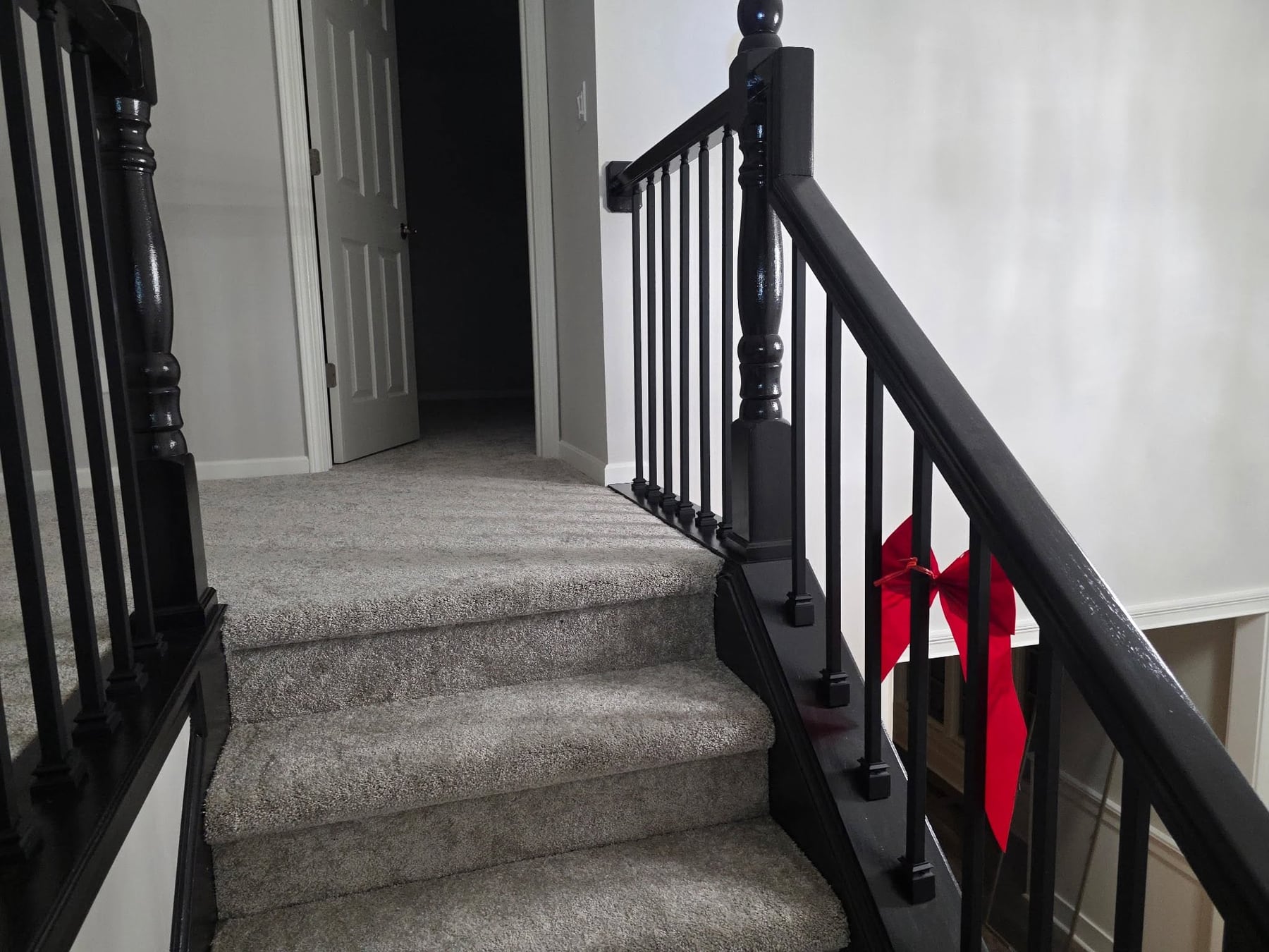 A staircase with a freshly painted black railing
