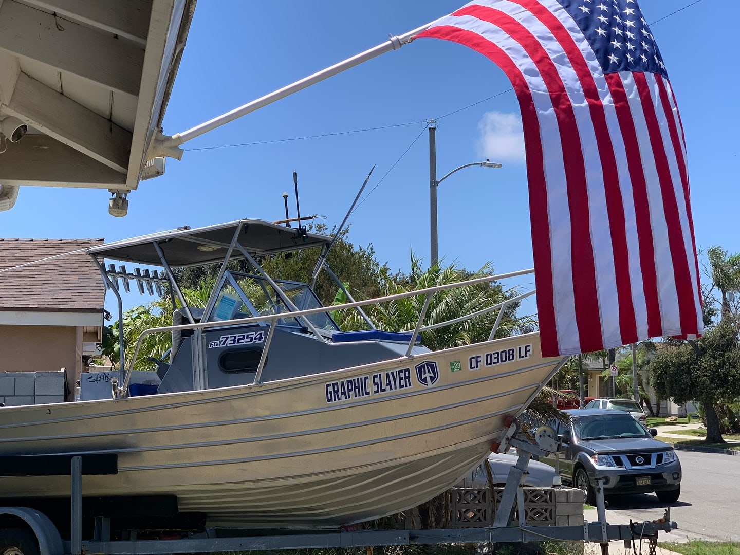 The Graphic Slayer on her trailer under an American flag