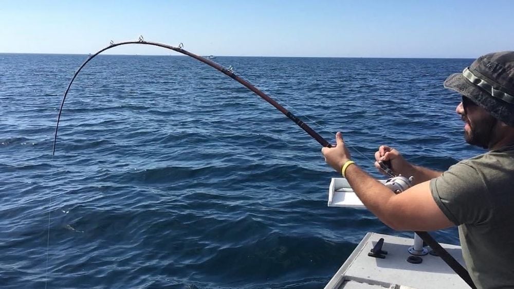 An angler leaning into a bent rod