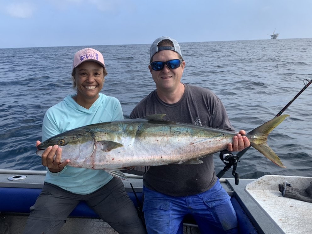 Two anglers with a yellowtail