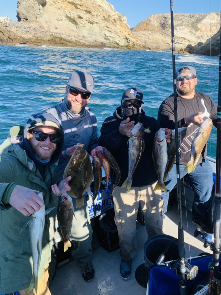Four anglers with rockfish under the Santa Rosa Island cliffs