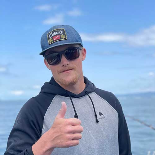 A Reel Addiction crew member giving a thumbs up on the water