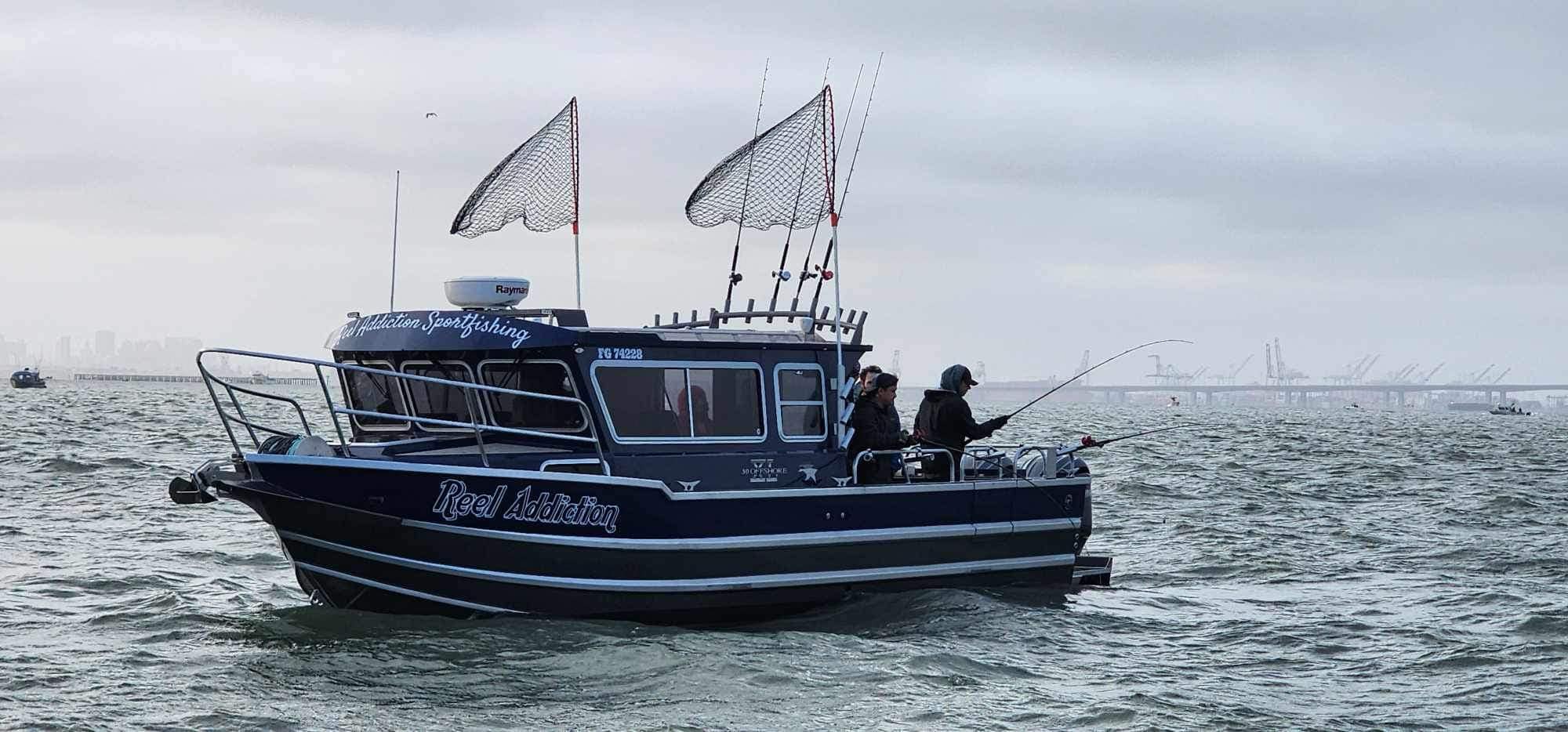 A Reel Addiction boat on San Francisco Bay with two anglers fishing
