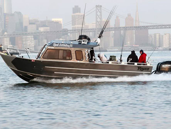 Reel Addiction II, the Sea Raider, running past the San Francisco skyline