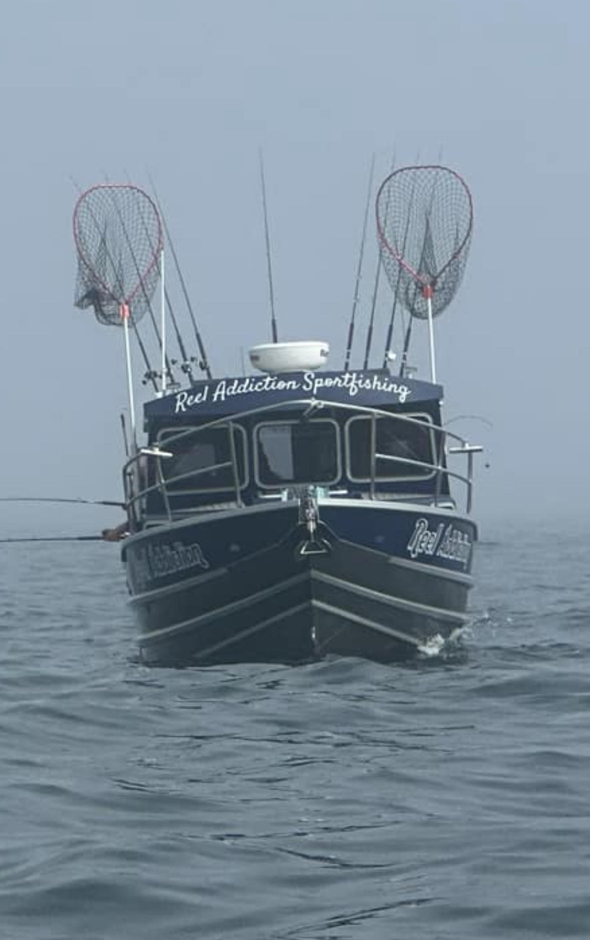 A Reel Addiction Sportfishing boat bow-on in the fog