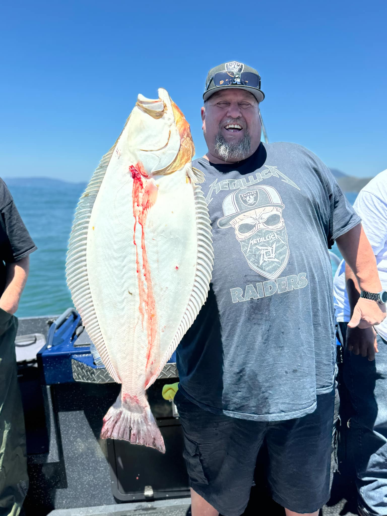 An angler holding a California halibut
