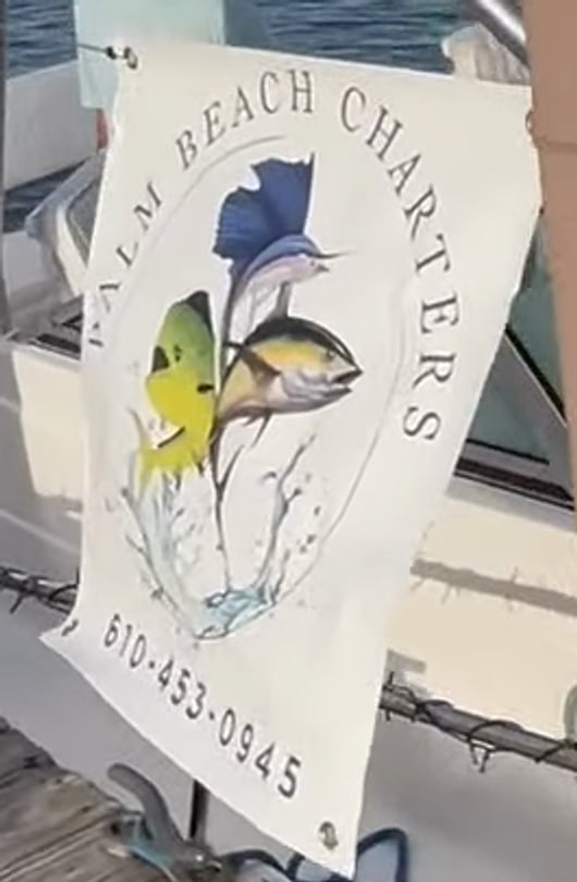 The Palm Beach Charters banner on the dock rail