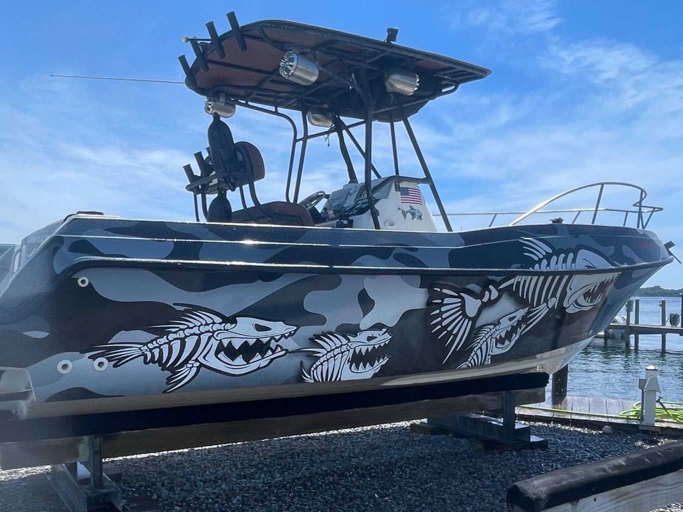 The Lady Mari, Salty Anchor Charters' boat, in a black and grey camo wrap on the lift at Shalimar Harbor Marina