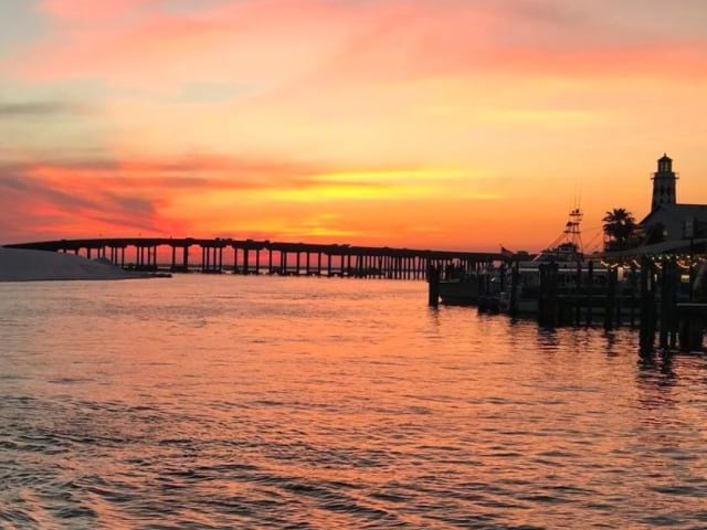 Sunset over the Destin bridge and harbor from the water