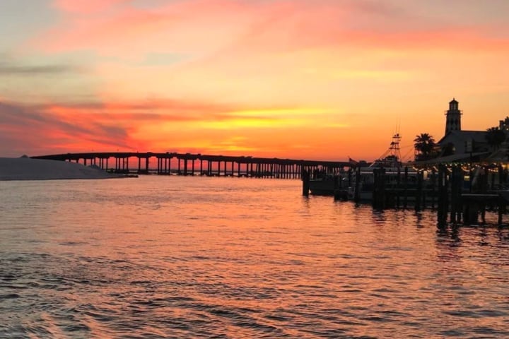Sunset over the Destin bridge and harbor from the water