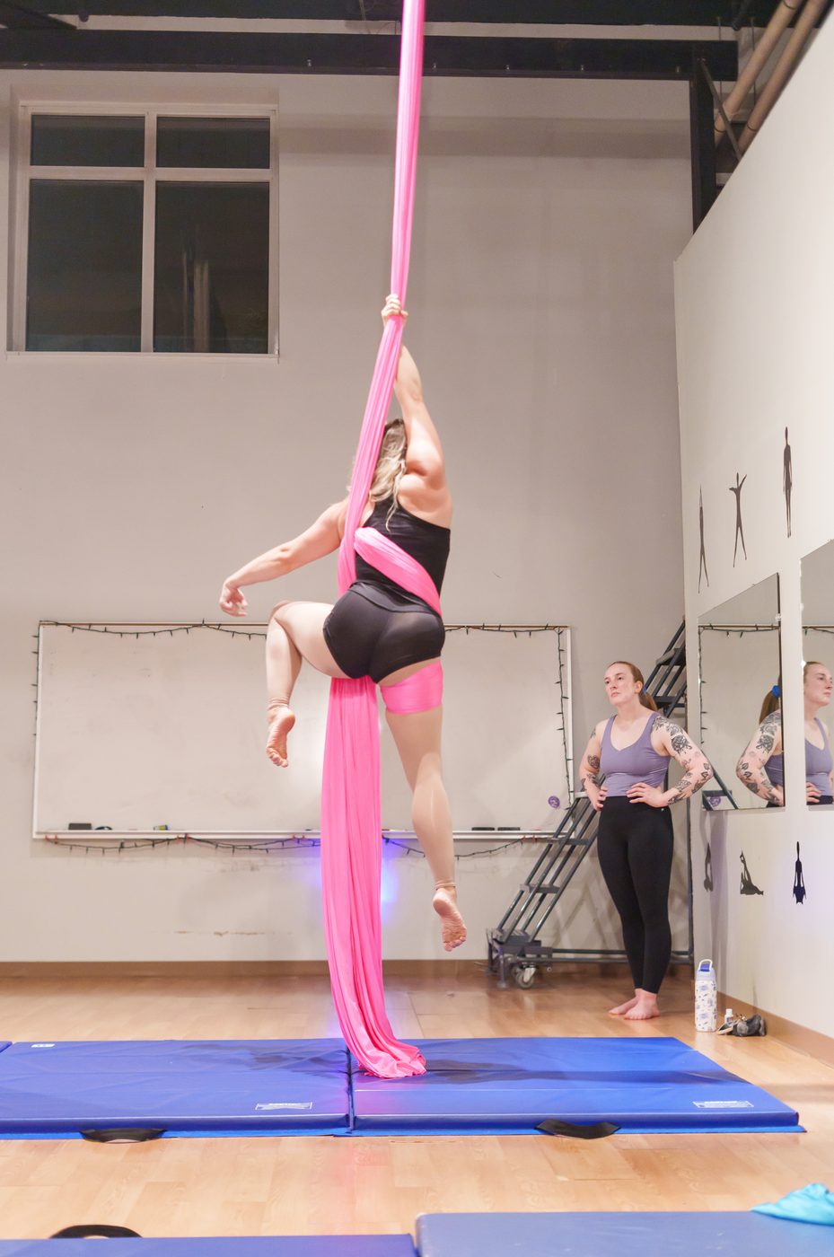 A student climbing the aerial silks at The Studio Cleveland